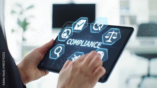 Wallpaper Mural Person Holding Black Tablet Displaying Compliance Icons in Bright Office Setting with White Walls and Modern Furnishings Torontodigital.ca