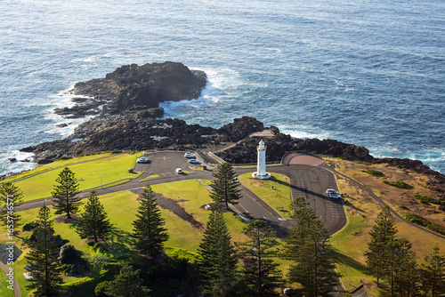 The beautifully scenic Kiama headland, home of the iconic Kiama Lighthouse and blowhole tourist attractions. Captured from high above the ocean on sunrise.