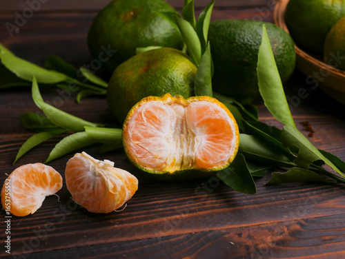 Jeruk keprok, fresh tangerines with green leaves on wooden table, fresh orange fruit, ripe tangerine, jeruk mandarin, delicious, healthy
