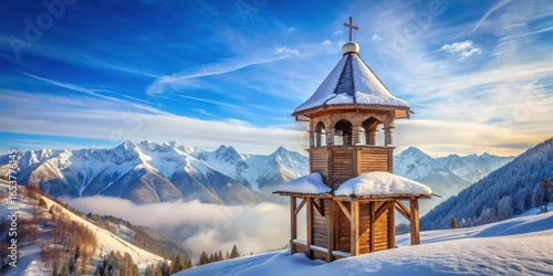 Ancient Russian Orthodox wooden bell tower over snow-covered mountains
