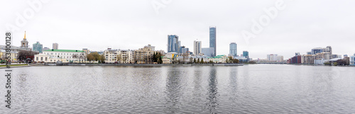 panoramic view of skyscrapers and modern and old houses in Yekaterinburgi Iset river in the foreground. Yekaterinburg, Russia