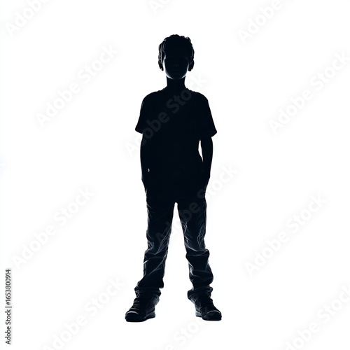 Silhouette of a young boy standing with his hands behind his back against a plain white background.