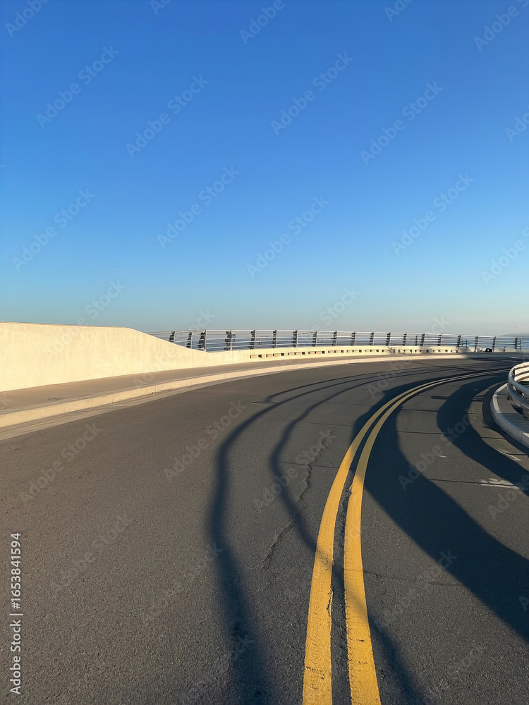 Fototapeta premium Modern Curved Road Bridge with Clear Blue Sky 
