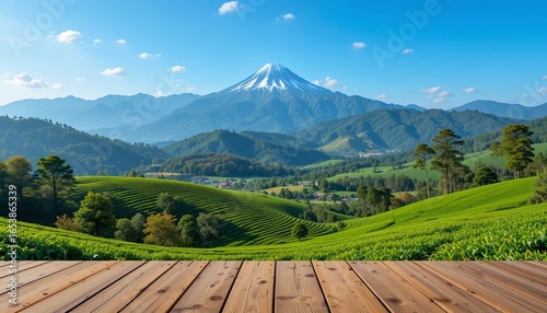 Wooden table top with tea garden and mountain background