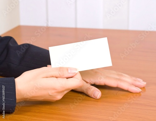 Blank business card held by hands