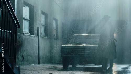 Quadro su tela Mysterious man walking in rain near vintage car at night
