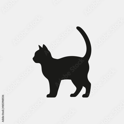 Black cat silhouette standing against a light background.