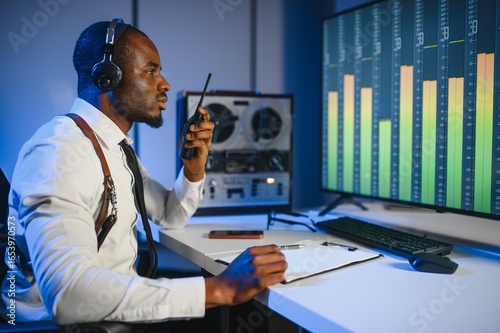 Obraz na plátně African american police officer records a telephone conversation on a tape recorder