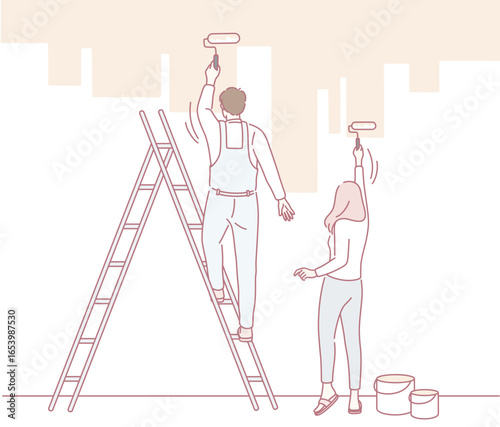 A couple is joyfully painting a colorful wall together, showcasing their teamwork and home improvement skills