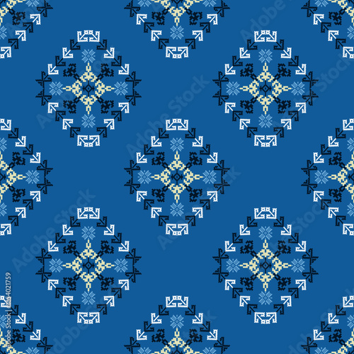 Pixel ethnic boho seamless pattern on blue background. Cross-stitch traditional ornament. Tribal pattern. Folk motif. Ideas for wallpaper, textile, wrapping, and background.