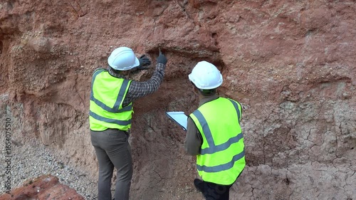 Geologist engineer working at mining site, excavating rock for analysis, checking soil minerals, identifying metals like gold, studying rock layers, and inspecting contamination for environmental safe