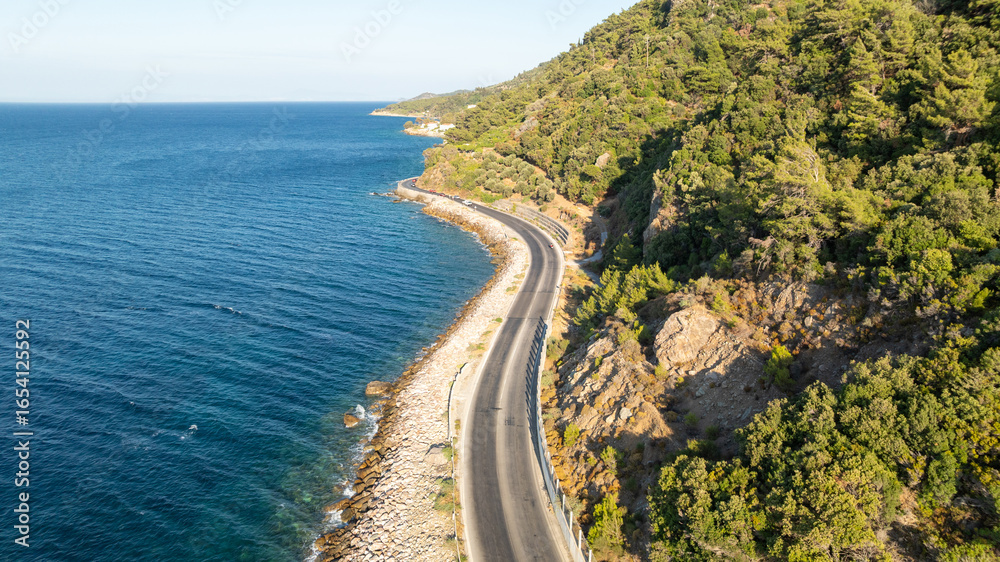 Obraz premium Aerial view of apshalt road next to the sea