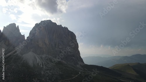 mountains dolomites italy alps bright sunrise at dawn from behind mountain peaks summer against blue sky aerial view lens flares. Vista de las dolomitas Italia con Drone.
