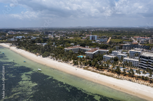 Aerial view of the coastline where golden sands meet turquoise waters near the hotels, Mombasa, Mombasa County, Kenya.