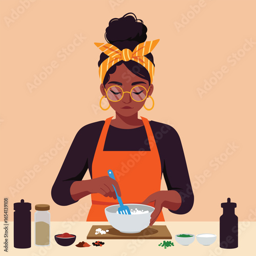 Stylish Black woman with glasses and a yellow headband cooking in an orange apron.