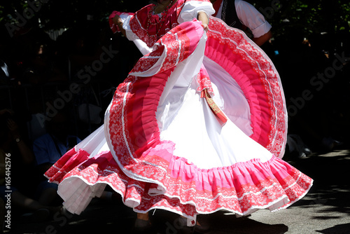 Dancers dancing and wearing one of the traditional folk costume from Mexico