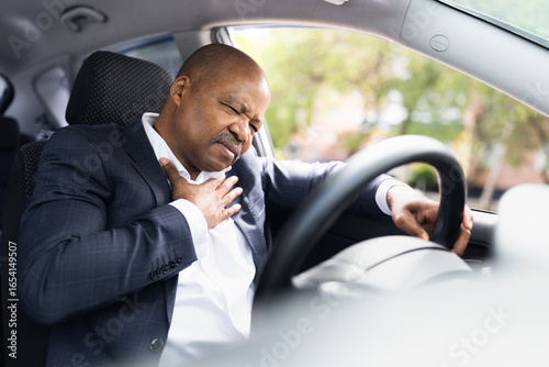 Принти на полотні African American businessman in car clutching chest in pain