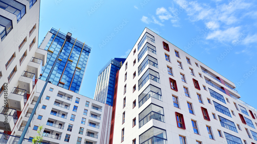 Fototapeta premium Modern new residential apartment house building complex. Exterior view of modern apartment building. New construction apartment or condo complex.
