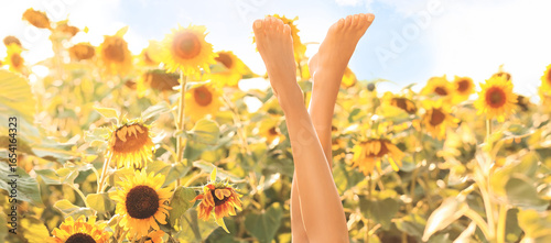 Barefoot young woman in sun...