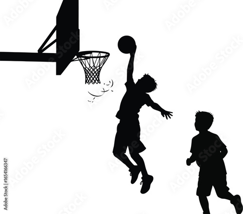 Silhouette of a basketball player dunking the ball with another player running