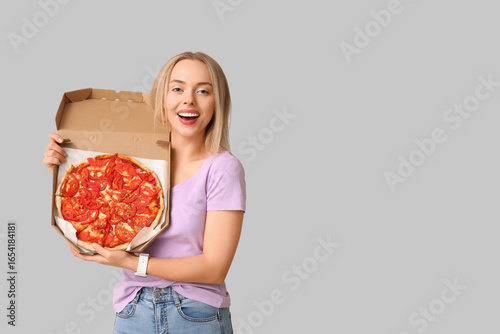 Happy young woman holding c...
