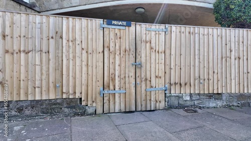 Wallpaper Mural Isle of Wight United Kingdom. 10.08.2025.  Video. Wooden security fencing with padlocked double gate. Torontodigital.ca