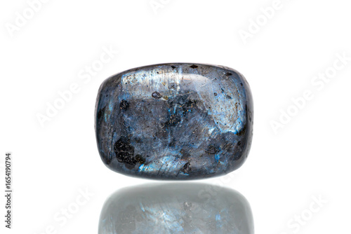 Closeup larvikite stone (blue pearl granite, black labradorite) with schiller effect, a variety of an igneous rock (monzonite) (selective focus)