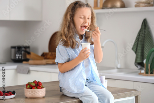 Cute little girl with spoon...
