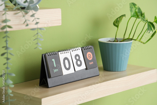 Wooden shelf with calendar ...