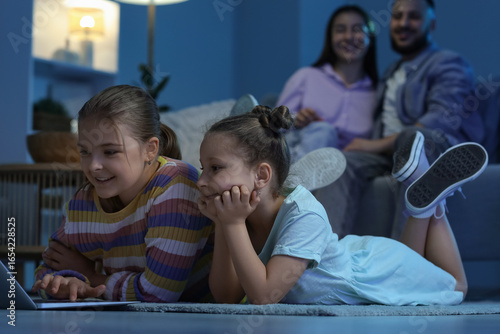 Cute sisters with laptop an...