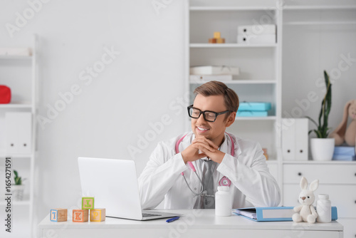 Smiling male pediatrician d...