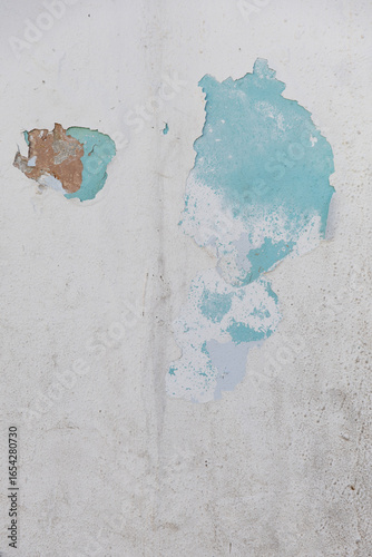 Vintage aged white and blue wall with texture showing effects of weather and time. Background photo. Copy Space 