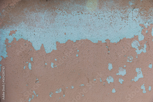 Vintage aged baby blue and beige wall with texture showing effects of weather and time. Background photo. Copy Space 