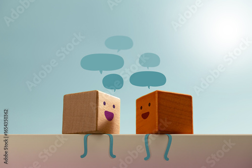 Fotografie Smiling wooden blocks engage in conversation with speech bubbles