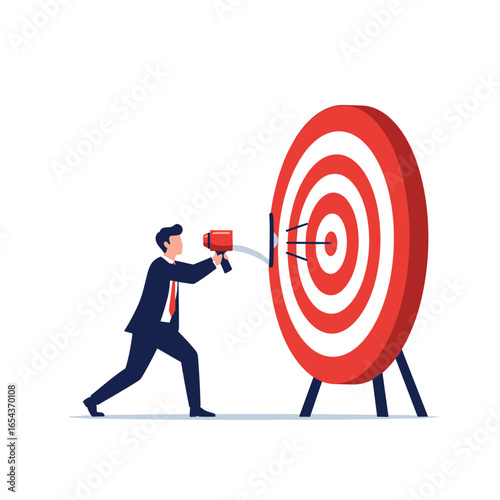 Businessman with megaphone announcing success directly at the bullseye of a target board