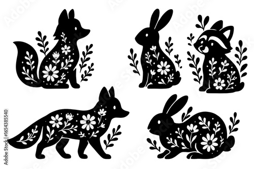 Woodland animal vector set with floral decoration. Cute folk art silhouettes of a fox, rabbit, and raccoon. Scandinavian style nature design elements. Black and white icons.