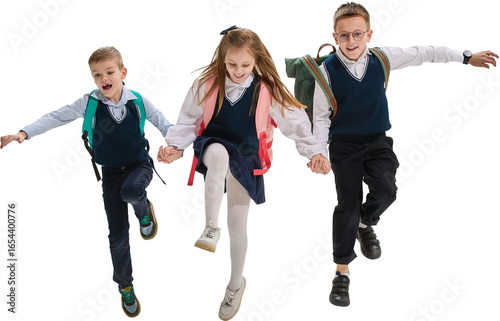 Fotografie Schoolchildren running hand in hand in uniforms with backpacks on transparent background