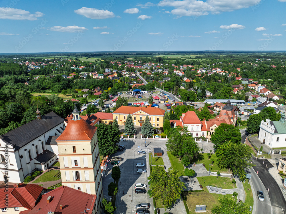 Naklejka premium Drone view of Lezajsk City Days celebration with concerts, stage lights, illumination, attractions for children and crowds enjoying music and summer festivities. City days celebration in Poland.