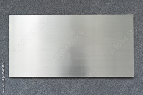 Metallic gray sign on concrete or stone wall, empty copy space, mock-up, background for designer