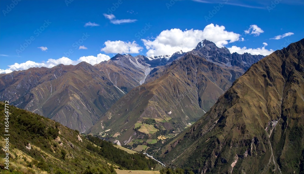 Fototapeta premium Mountainous valley vista under a vibrant blue sky
