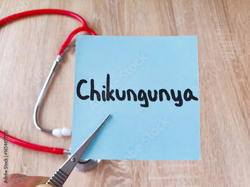 Chikungunya text, word Chikungunya note in tweezers on a stethoscope background, virus, treatment, medical concept.