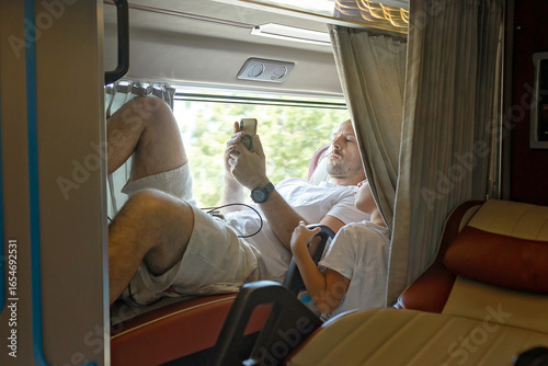 Child, boy, traveling in a sleeper bus in Vietnam, bed seat in the bus, kid on vacation summer