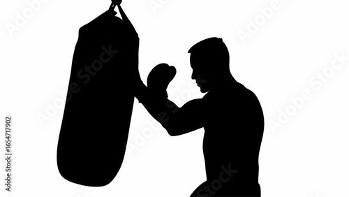Silhouette of a boxer punching a heavy bag in a gym for training and fitness, shown in black and white