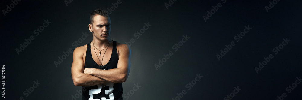 Fototapeta premium Serious Man in Dark Setting, Wide Banner with Copy Space