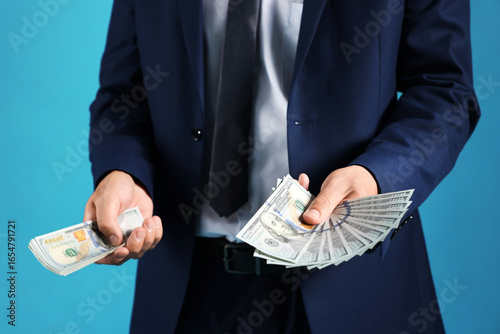 Wallpaper Mural Man with dollar bills on blue background, closeup Torontodigital.ca