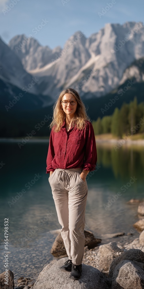 Naklejka premium Caucasian female adult enjoying serene mountain lake views in casual outfit