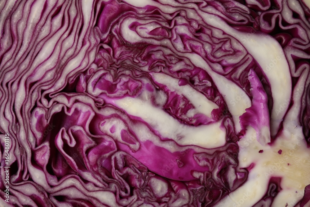 Obraz premium Cut fresh red cabbage as background, closeup