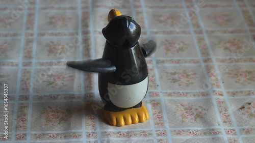 Plastic mechanical toy spinning on a kitchen table. 