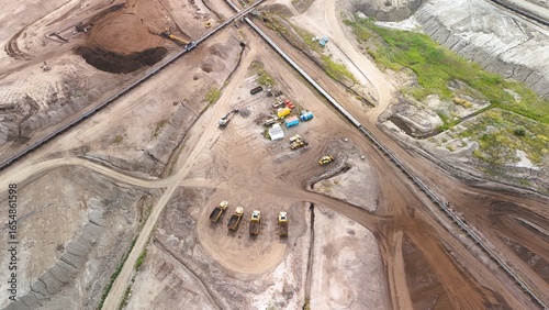 Aerial View of Construction Site with Heavy Equipment and Dump Trucks – Industrial Earthmoving and Mining Operation