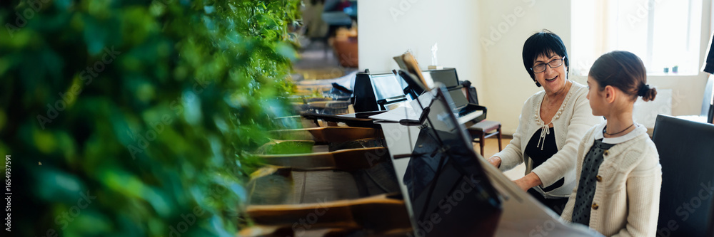 Fototapeta premium Piano Lesson Interaction Wide Banner with Copy Space